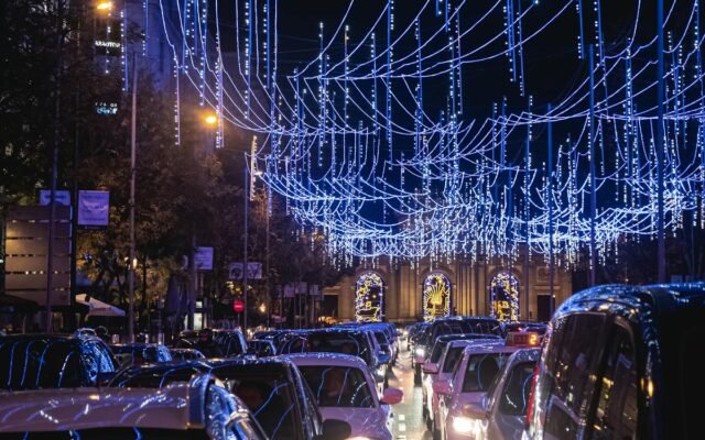 Automašīnas uz ceļa ar izgaismotām virtenēm nakts laikā